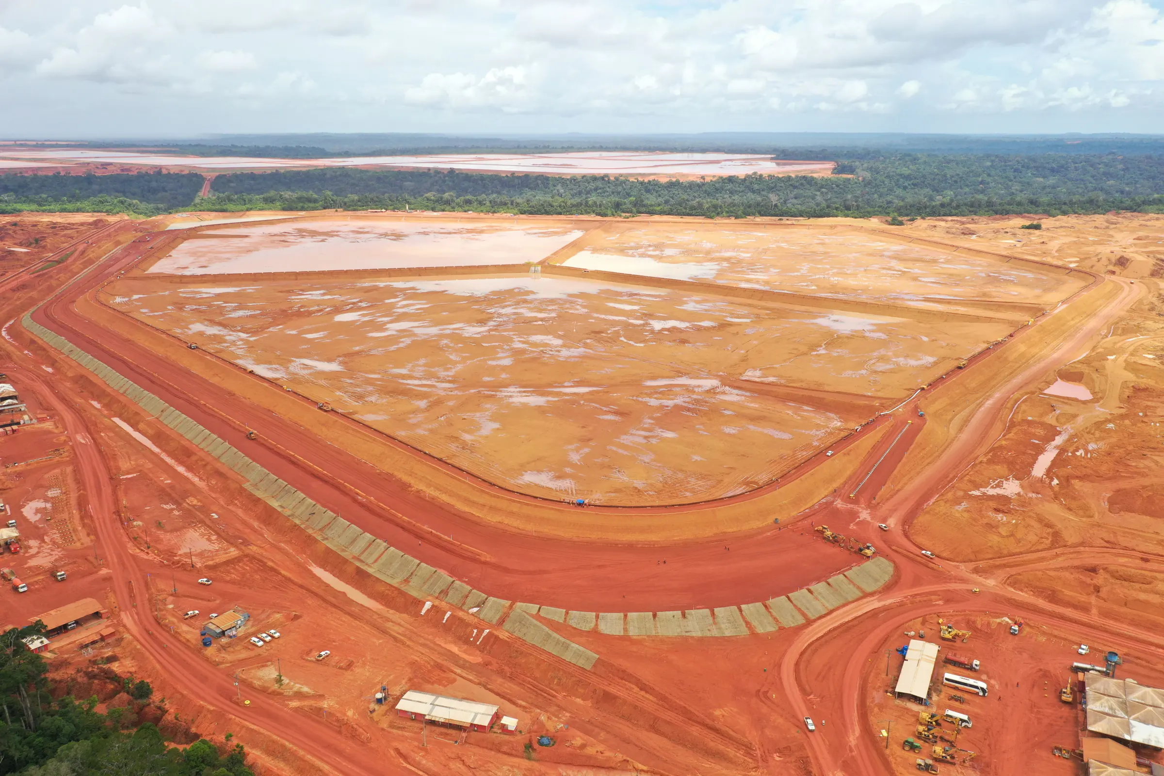 Vista aérea geral da Barragem SP24, com o reservatório e os taludes em bermas